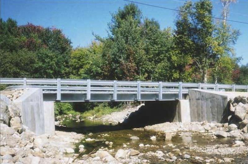 Photograph A: a short bridge deck spanning between two concrete abutments